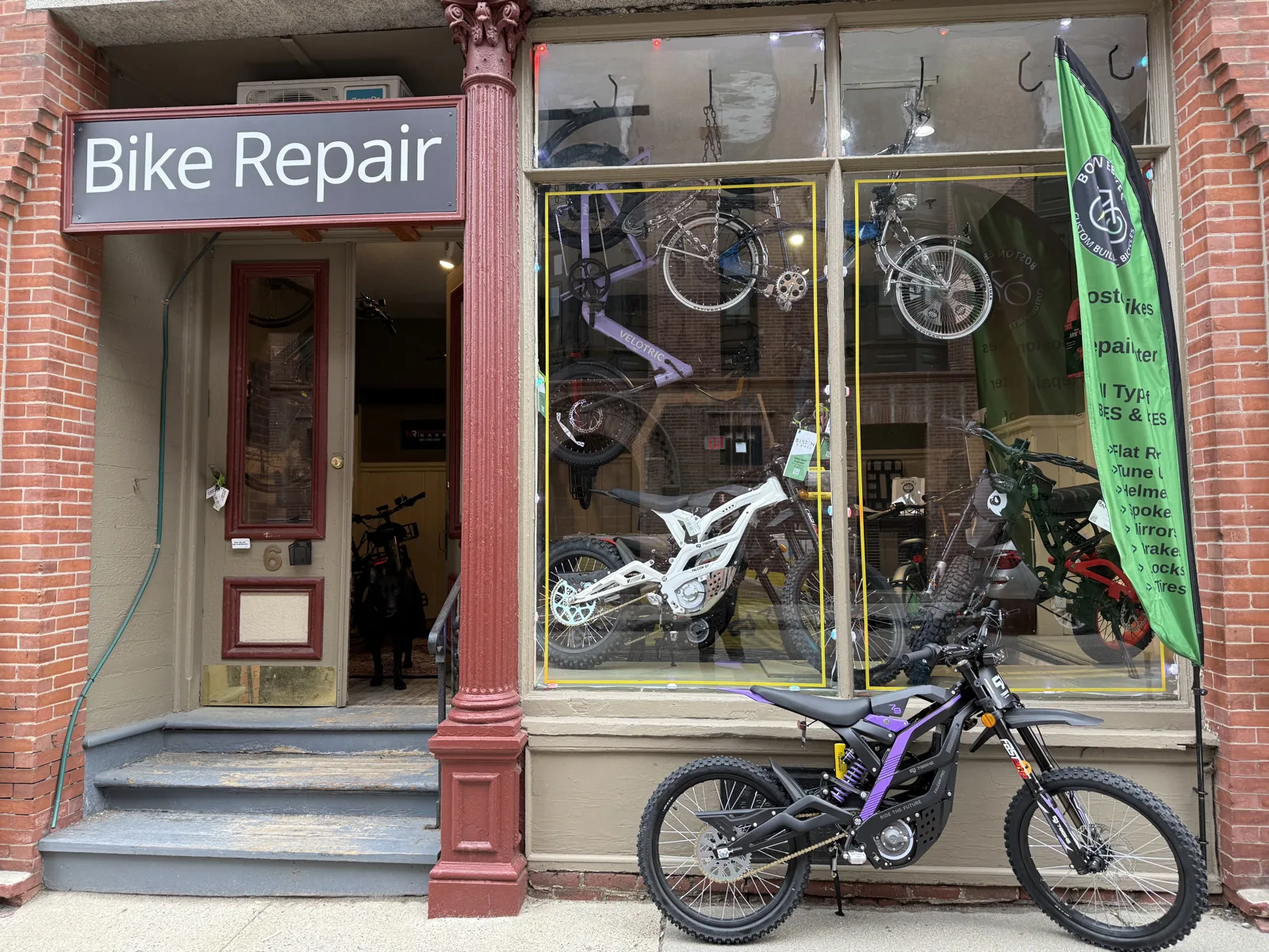 The Boston E-Bikes repair shop entrance at 6 Davis Avenue, with bikes in the window
